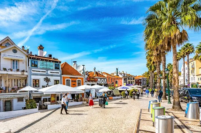 The palm-lined seafront promenade in Cascais with cafés and white houses